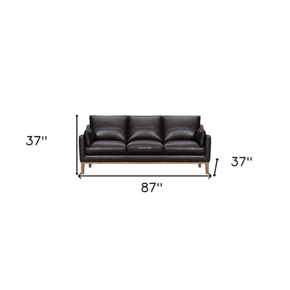 87" Dark Brown Leather Sofa And Toss Pillows With Brown Legs